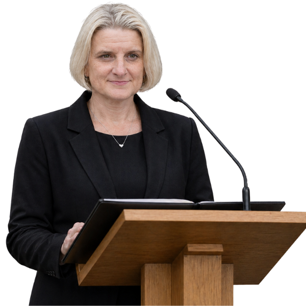 Hannah Illingworth Funeral Celebrant dressed in somber clothes at a lectern delivering a funeral service